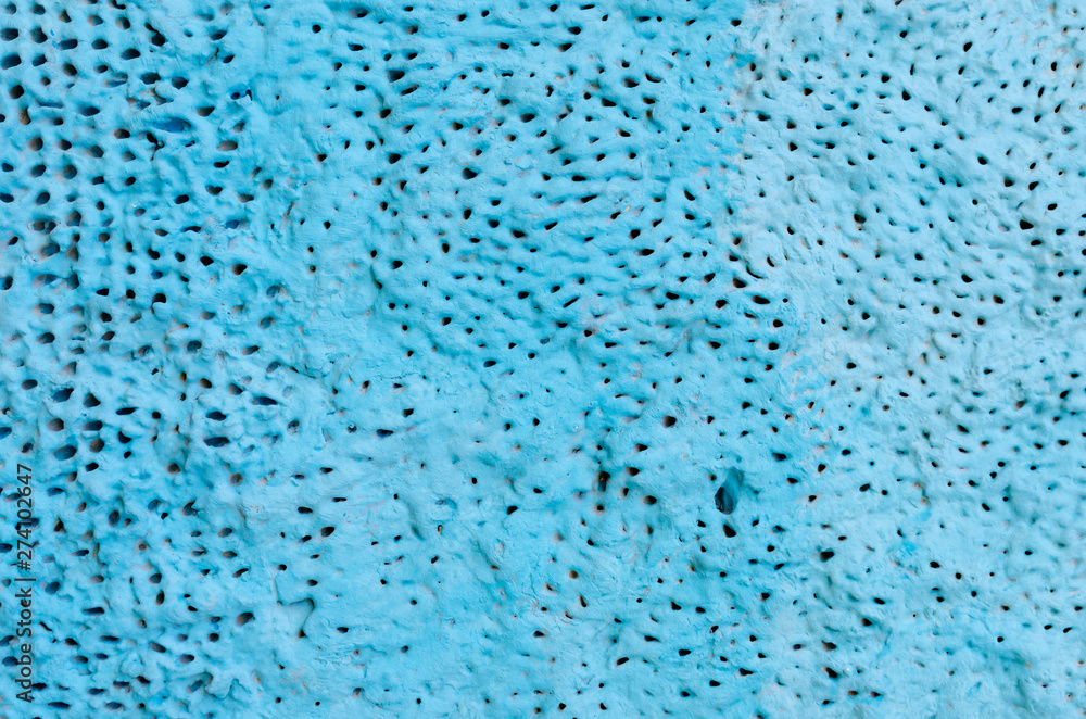 Texture concrete turquoise wall with holes