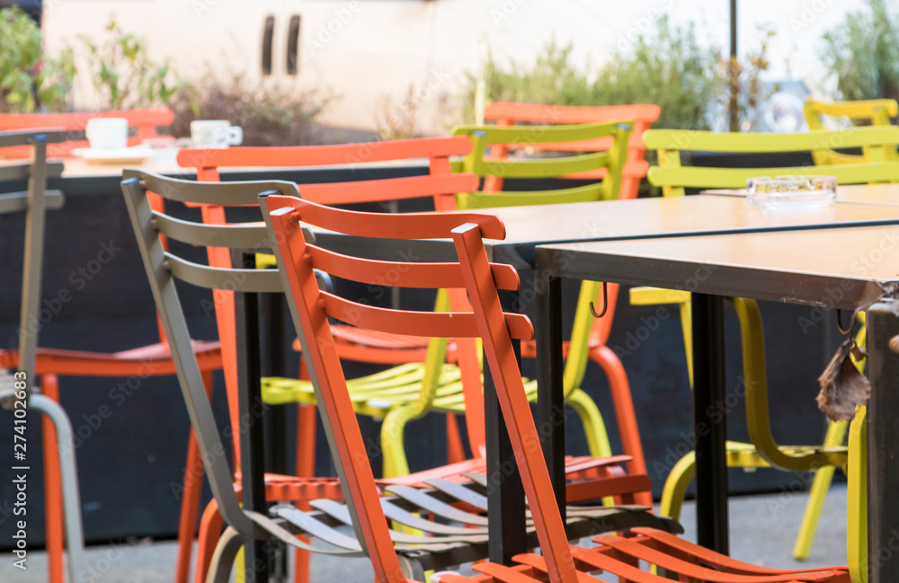 empty tables outside a bar