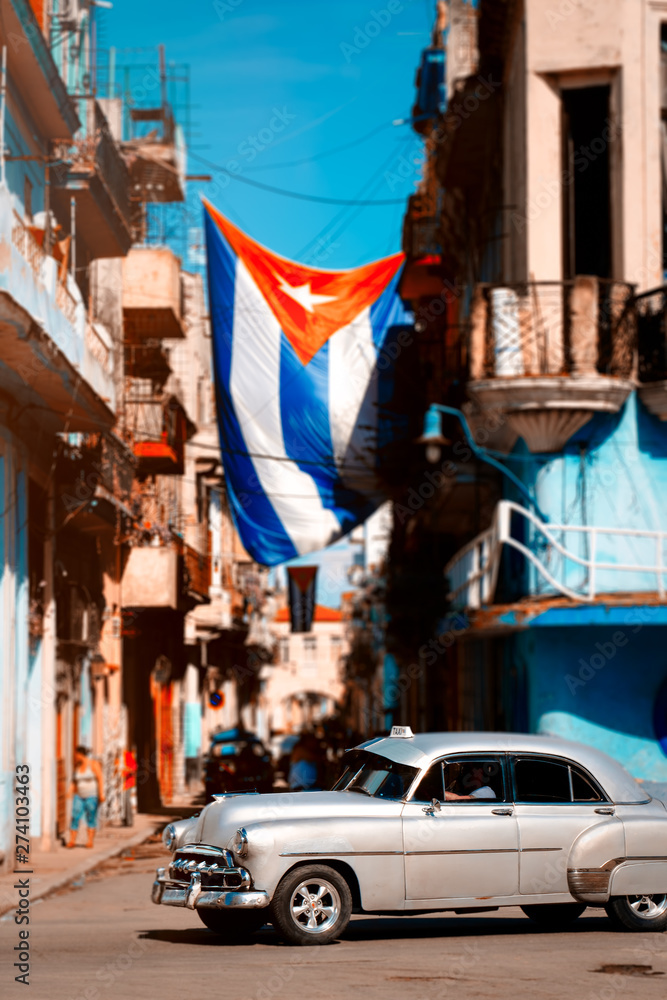 Antique car and cuban flag in Old Havana