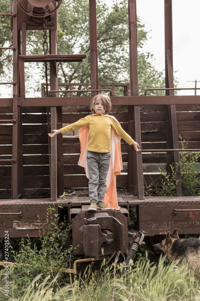 5 year old boy wearing a cape in rural location 5 year old boy wearing a cape in rural location