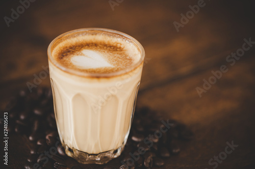 Fototapeta Naklejka Na Ścianę i Meble -  Cup of coffee latte on wood table in coffee shop cafe
