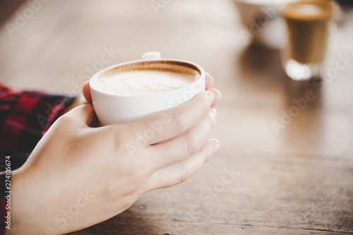 People are drinking a latte in coffee shop cafe