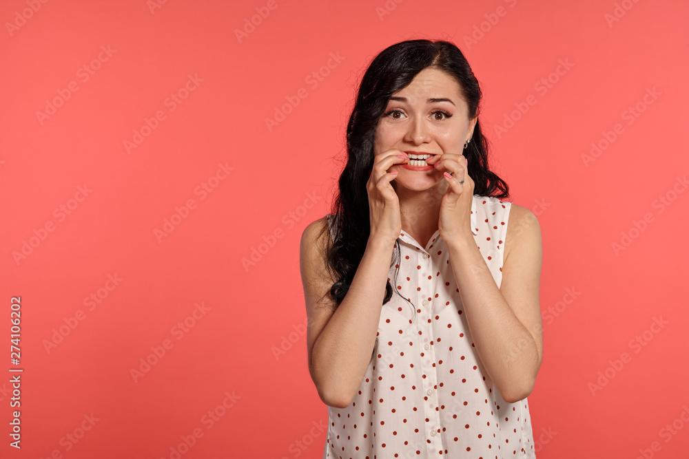 Studio shot of a beautiful girl teenager posing over a pink background. Studio shot of a beautiful girl teenager posing over a pink background.