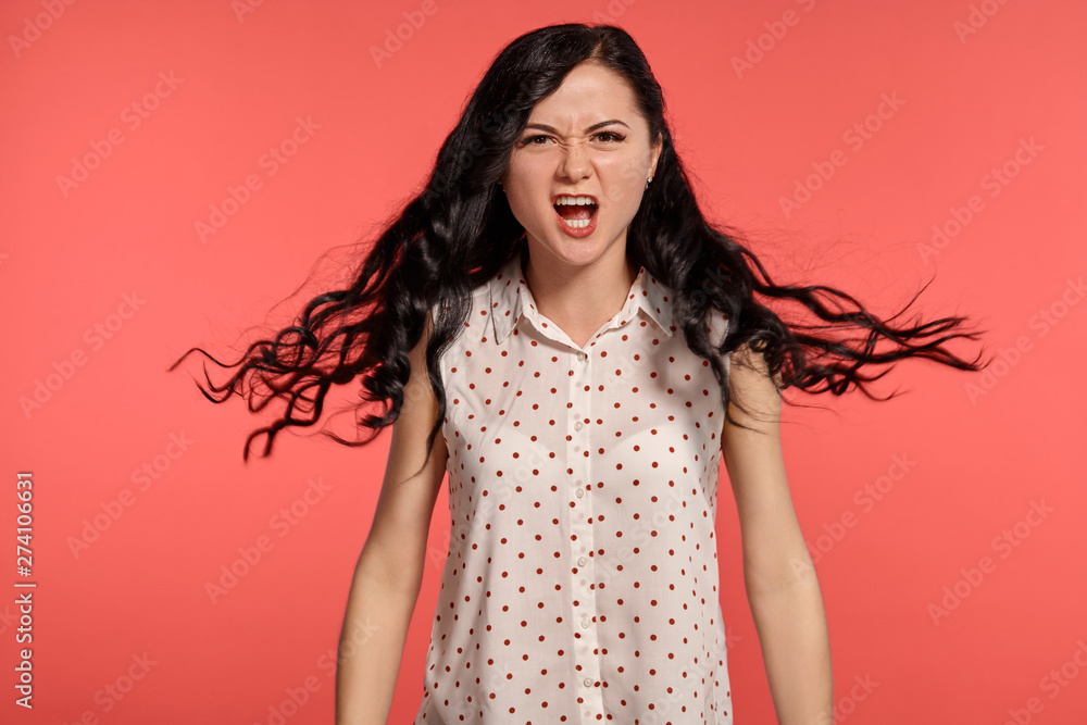 Studio shot of a beautiful girl teenager posing over a pink background. Studio shot of a beautiful girl teenager posing over a pink background.
