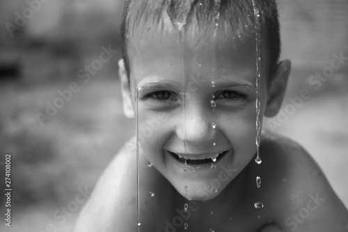 black and white portrait of a beautiful boy in the rain