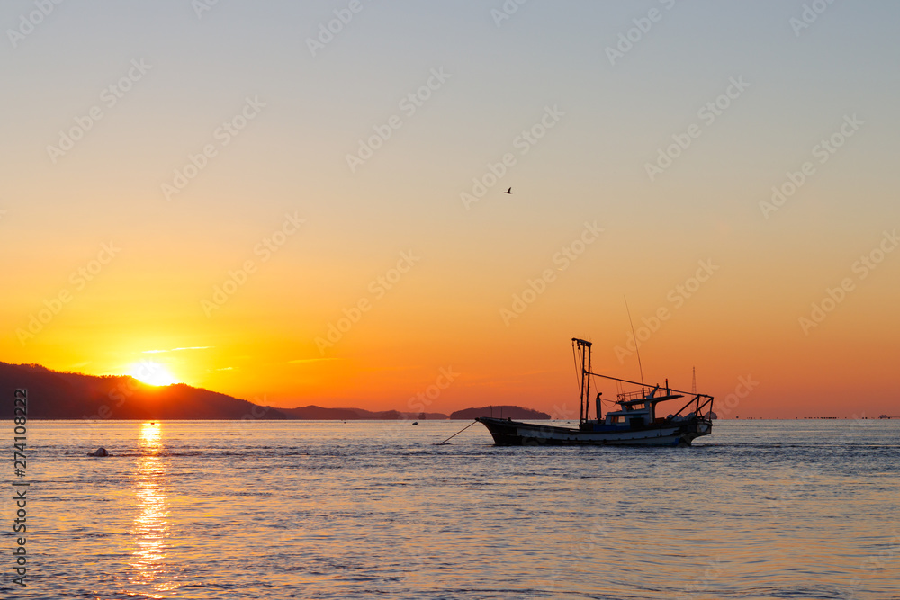 Anchored sea fishing boat.  sunset and fishing boat.