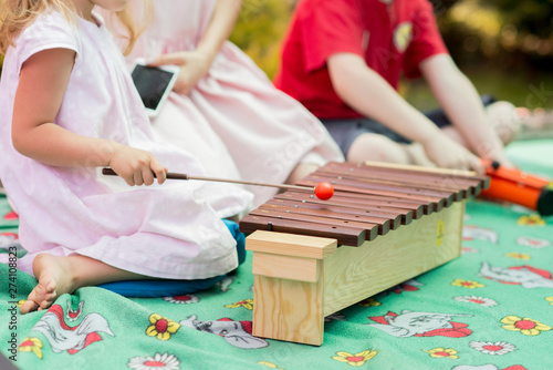 Baby girl playing a musical instrument xylophone photo