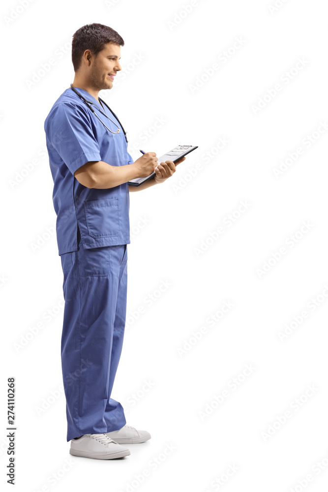 Male doctor in a blue uniform writing on a clipboard Male doctor in a blue uniform writing on a clipboard