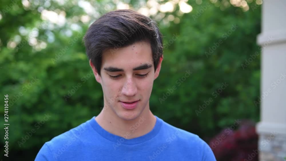 Young Man with cell phone messanging smiling outside Young Man with cell phone messanging smiling outside