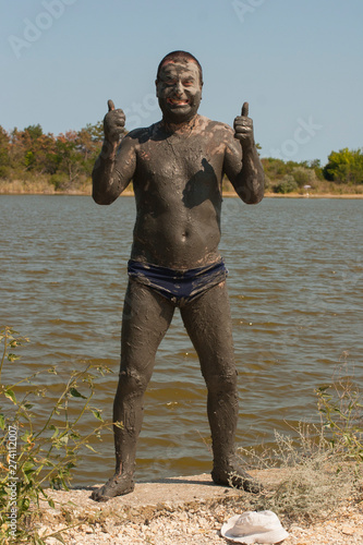 Mud Spa treatments on the Black sea coast. A man is vacationing in Bulgaria - as he can. Soiled men in full growth. 