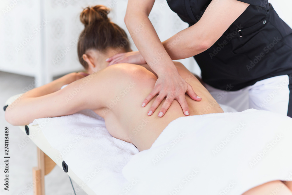 Relaxing caucasian woman during treatment massage in the clinic. Relaxing caucasian woman during treatment massage in the clinic.
