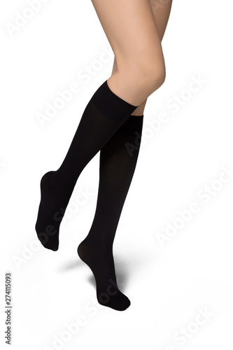 Female legs in black socks on white background
