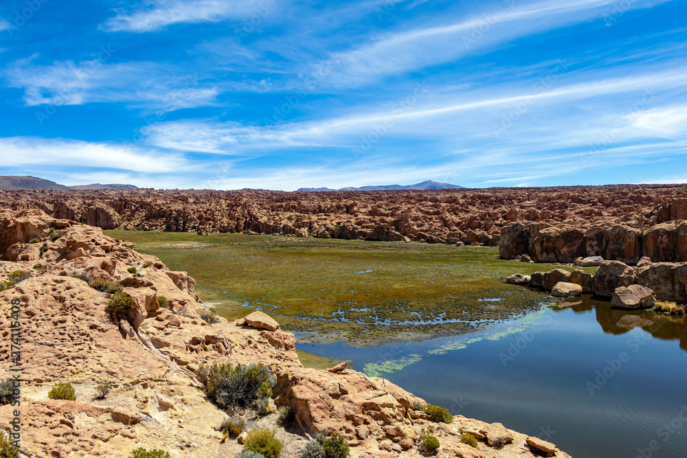 View of the Laguna Negra, Black lagoon Lake wedged between rock formations in Altiplano, Bolivia