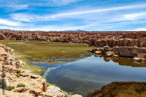 View of the Laguna Negra, Black lagoon Lake wedged between rock formations in Altiplano, Bolivia