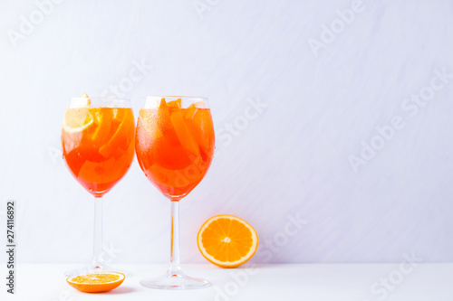 Cocktail Aperol Spritz with mint leaves on a white background. Italian cocktail aperol spritz on white background