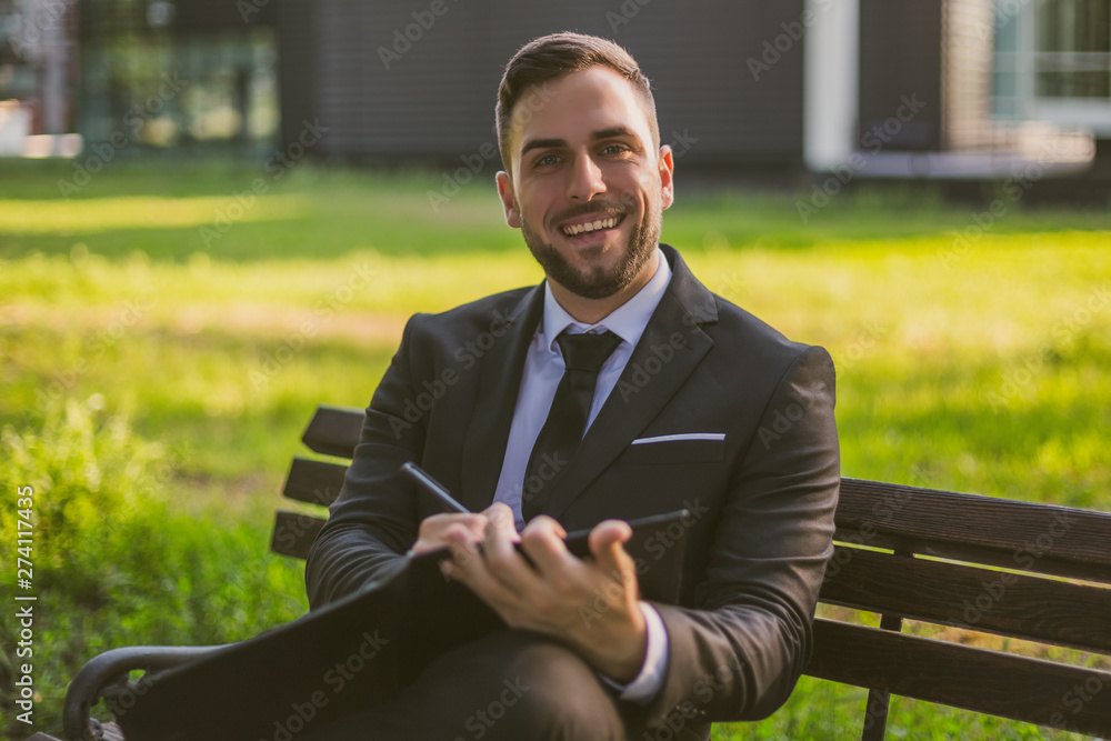 Elegant businessman working outdoor.Toned photo. Elegant businessman working outdoor.Toned photo.