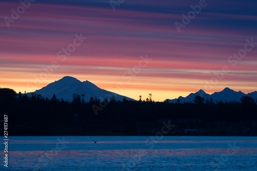 Dramatic Sunrise Over Mt. Baker and Bellingham Bay.  First light behind Mt. Baker, Washington, can be a dramatic and colorful event in the Pacific Northwest. photo