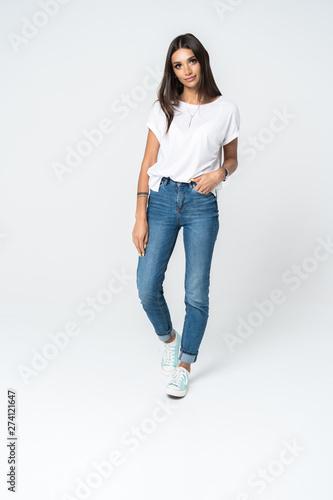 Full length portrait of a smiling pretty woman isolated over white background.