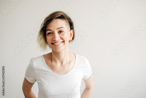 Beautiful young girl with short hair is smiling.