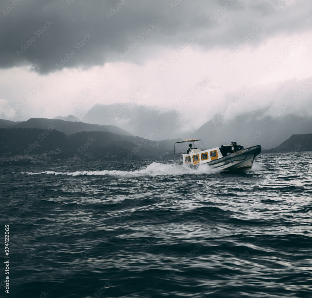 Fototapeta premium boat in rocky waters on lake