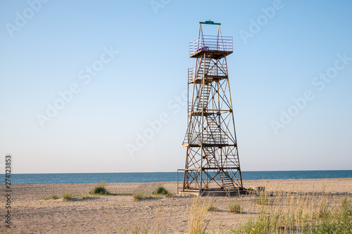  Lifeguard observation tower stands on the beach of the sea