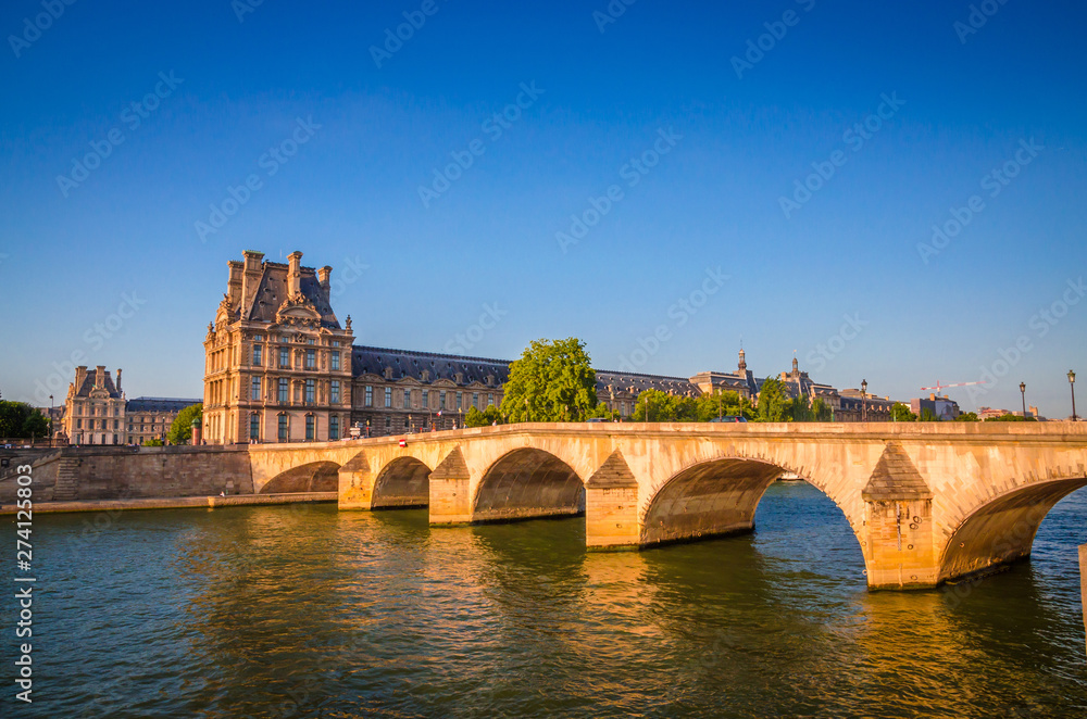 Sunset view on bridge and buildings on the Seine river in Paris, France