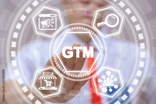 GTM Go To Market Business Marketing Management Model. Man uses on virtual screen of future and touches acronym: gtm.