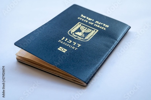 A blue passport of the State of Israel on a light blue background. Israel citizenship concept, Israeli bio-metric "darkon" passport illustrative image. Jewish nation state concept.
