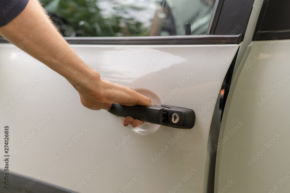 casual person opens the white car door on the parking, car rental concept casual person opens the white car door on the parking, car rental concept