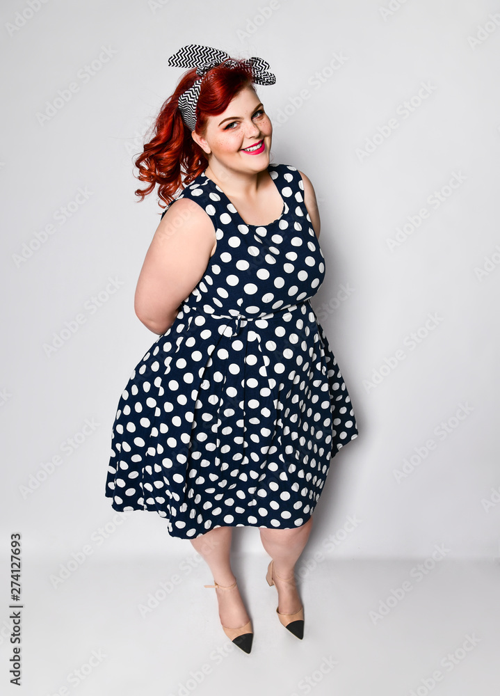 Pin up woman portrait. Beautiful retro female in polka dot dress with red lips and manicure nails and old fashion hairstyle Pin up woman portrait. Beautiful retro female in polka dot dress with red lips and manicure nails and old fashion hairstyle
