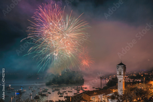 Firework of San Giovanni Festival on Lake Como at Ossuccio with the bell tower