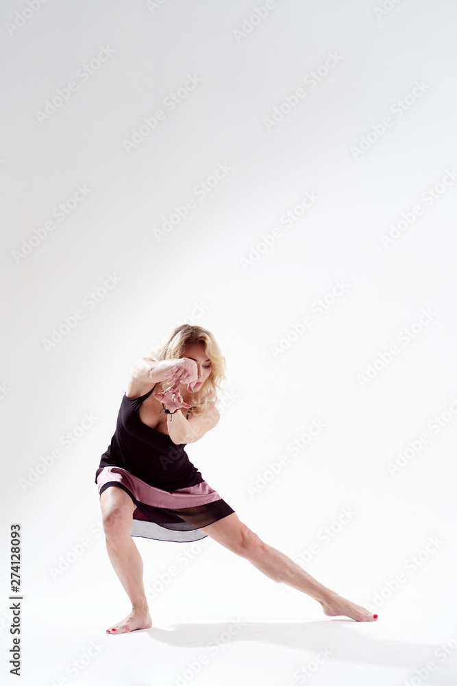 Photo of long-haired blonde dancing in studio Photo of long-haired blonde dancing in studio