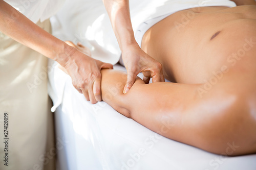 Asian man laying on bed for herb compress and pampering thai massage therapist, relaxation and wellness lifestyle.