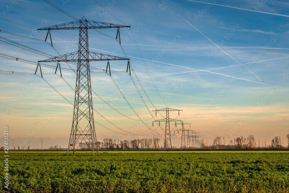 © Ruud Morijn - High voltage towers with thick hanging power cables in a rural landscape in the Netherlands © Ruud Morijn - High voltage towers with thick hanging power cables in a rural landscape in the Netherlands