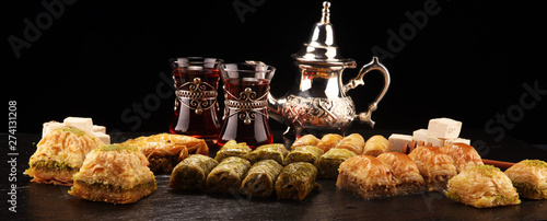 Middle eastern or arabic dishes. Turkish Dessert Baklava with pistachio on dishes photo