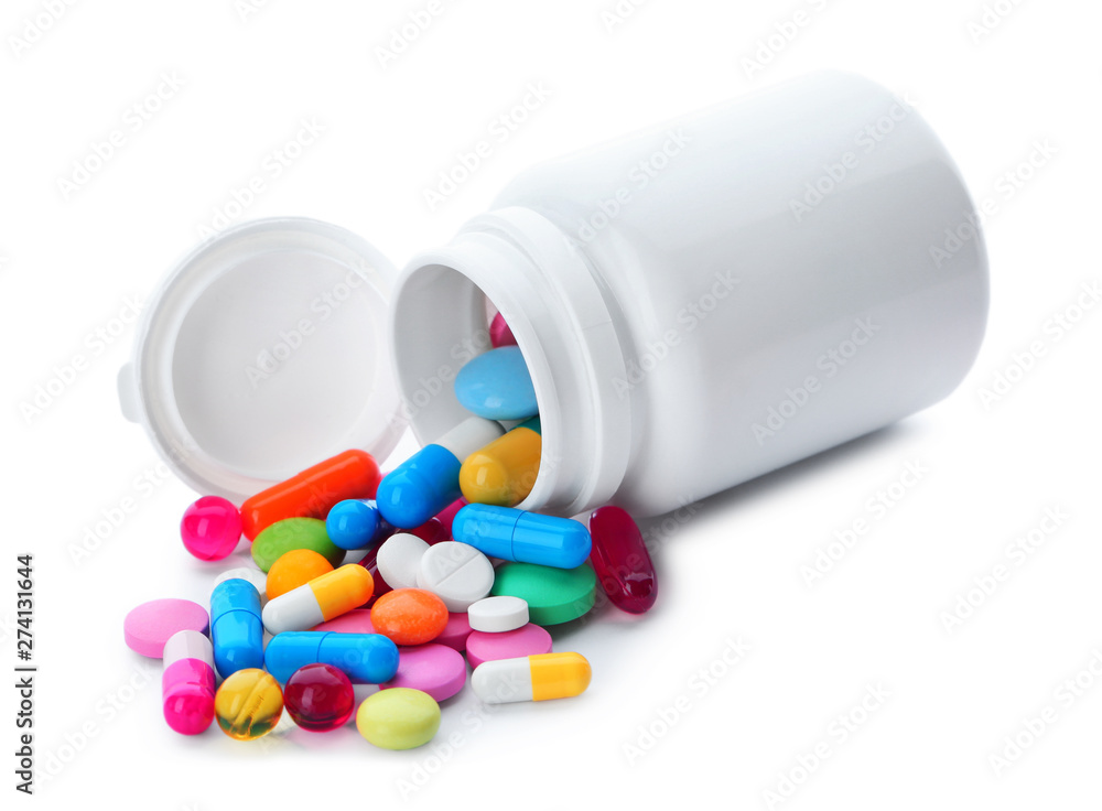 Scattered pills and open container isolated on white