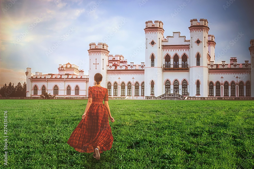 Young beautiful princess in a long red dress on the castle background in sunny day. Art processing..