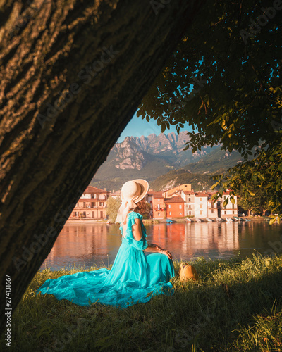 A girl posing in front of Pescarenico on the Adda River next to Lake Como and the city of Lecco photo