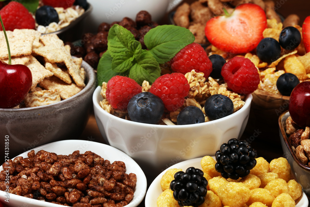 Cereal. Bowls of various cereals, berries and milk for breakfast. Muesli with kids cereals. Cereal. Bowls of various cereals, berries and milk for breakfast. Muesli with kids cereals.