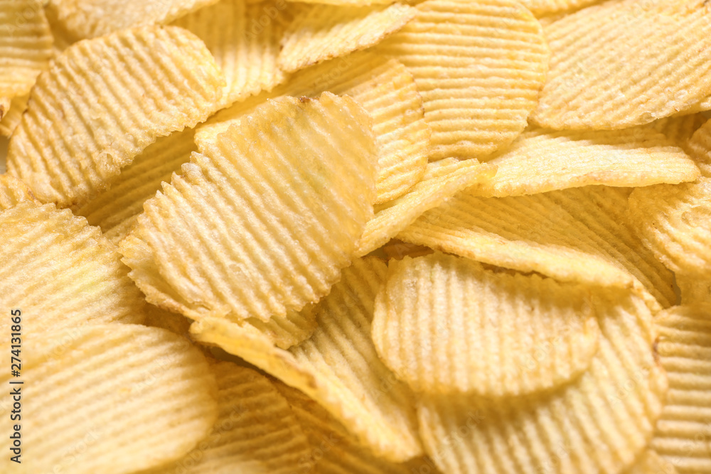 Pile of crispy potato chips as background, closeup Pile of crispy potato chips as background, closeup