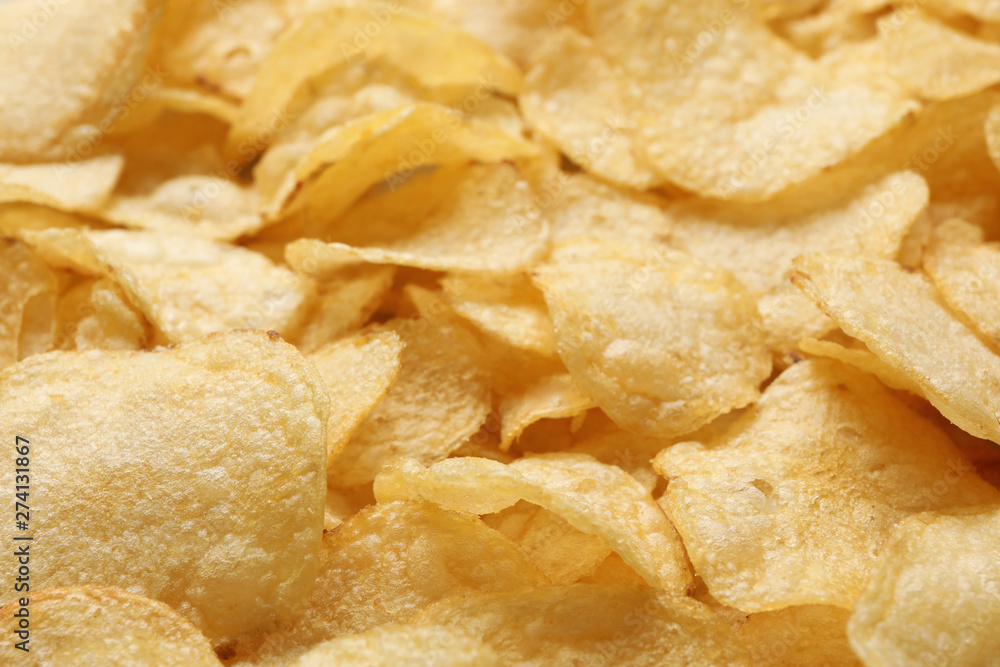 Pile of crispy potato chips as background, closeup Pile of crispy potato chips as background, closeup