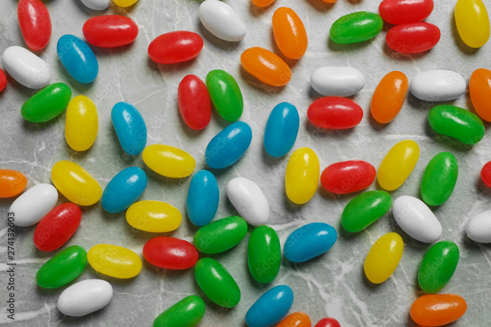 Flat lay composition with delicious jelly beans on stone background Flat lay composition with delicious jelly beans on stone background