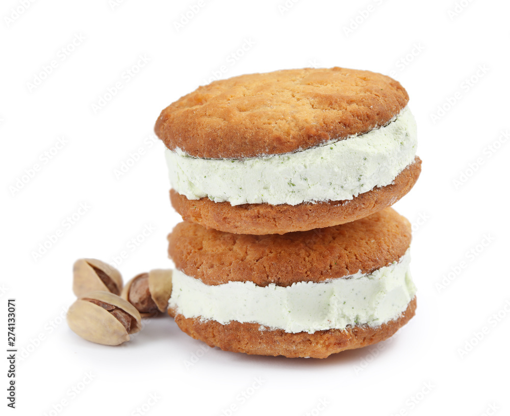 Sweet delicious ice cream cookie sandwiches and pistachios on white background Sweet delicious ice cream cookie sandwiches and pistachios on white background