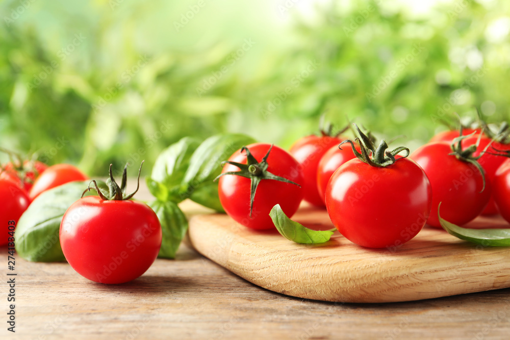 Board with fresh cherry tomatoes on wooden table Board with fresh cherry tomatoes on wooden table