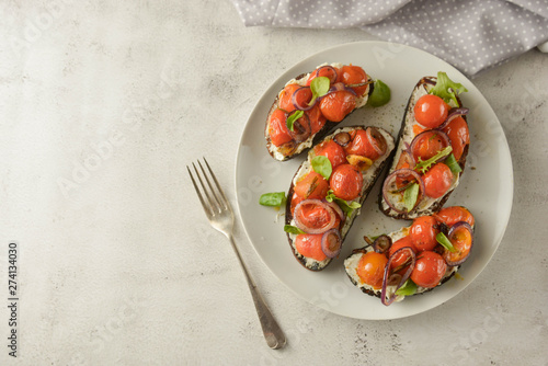 Bruschetta with cherry tomatoes and cheese cream. Healthy, vegan food, snack. Copy space.