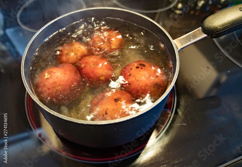 Red potatoes in boiling water