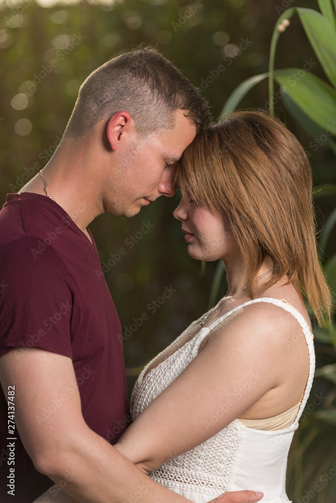 Loving man and happy woman in a spring blooming park. Happy mature couple in love embracing outdoor Loving man and happy woman in a spring blooming park. Happy mature couple in love embracing outdoor