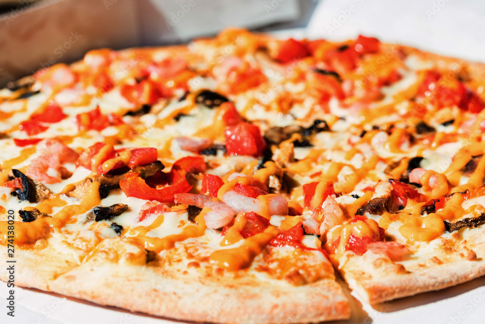 Delicious fresh pizza with shrimps , mushrooms and cheese close up in paper box Delicious fresh pizza with shrimps , mushrooms and cheese close up in paper box