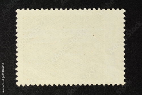 Blank vintage postage stamp on black background. Mockup with perforations for your picture text or design 2.