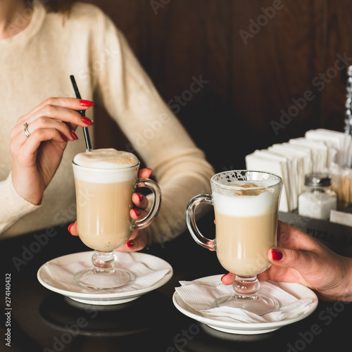 cup of coffee with milk and cookies on wooden background